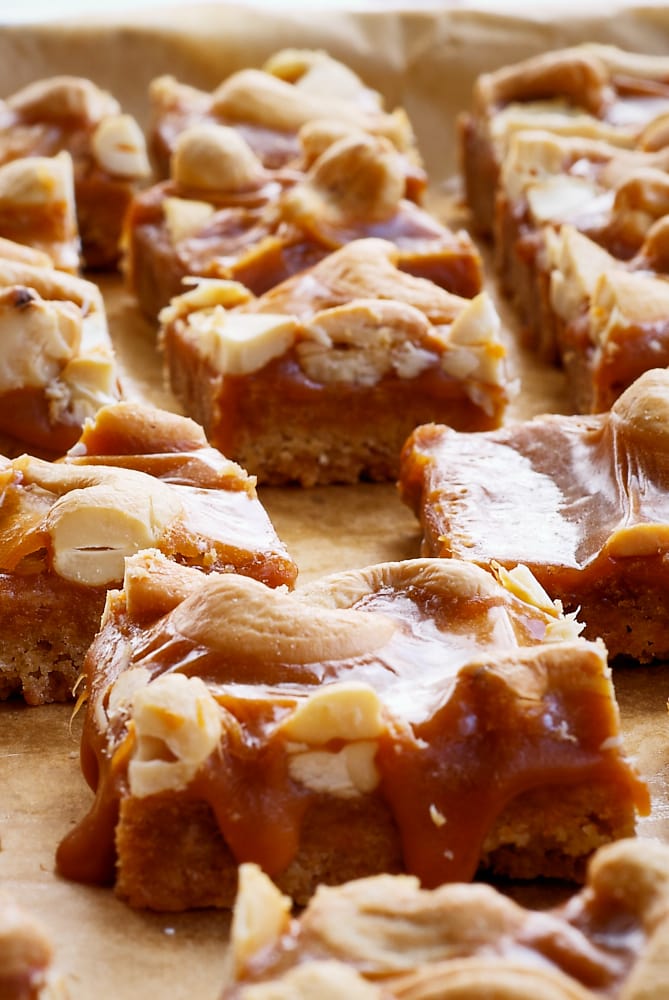 sliced Butterscotch Cashew Bars on a parchment paper-lined baking pan