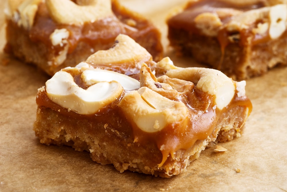 sliced Butterscotch Cashew Bars on parchment paper