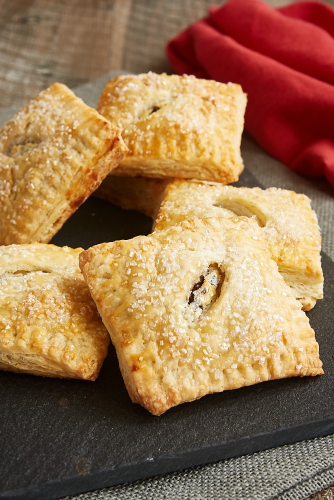 Chocolate Chip Cream Cheese Hand Pies piled on a black serving tray