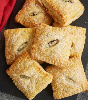 overhead view of Chocolate Chip Cream Cheese Hand Pies on a black serving tray