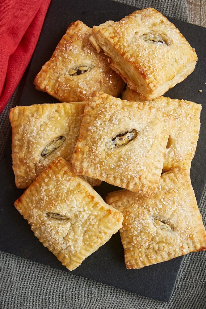 overhead view of Chocolate Chip Cream Cheese Hand Pies on a black serving tray