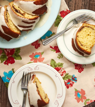overhead view of slices of Cinnamon Breakfast Cake on color-rimmed white plates