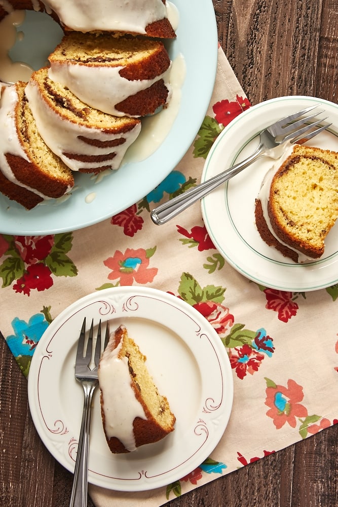 overhead view of slices of Cinnamon Breakfast Cake on color-rimmed white plates