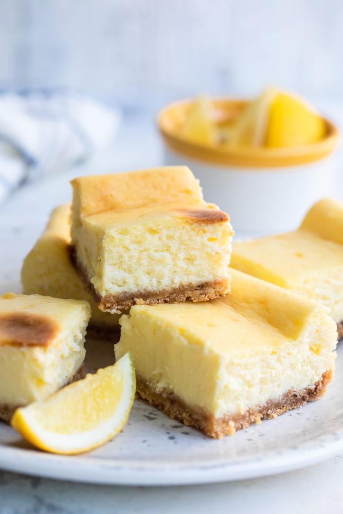 Limoncello Cheesecake Squares stacked on a white plate