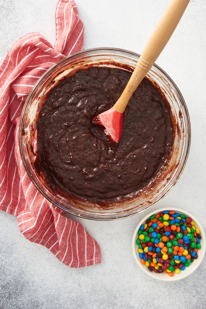 overhead view of brownie batter in a glass mixing bowl