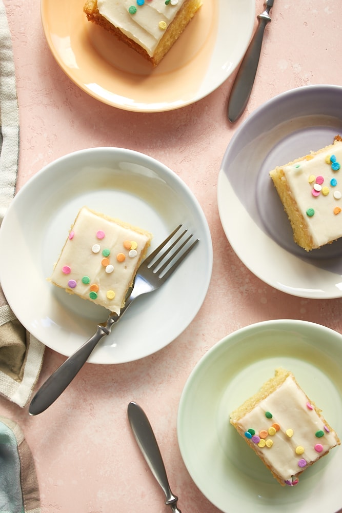 Overhead view of Vanilla Cake pieces on colorful plates