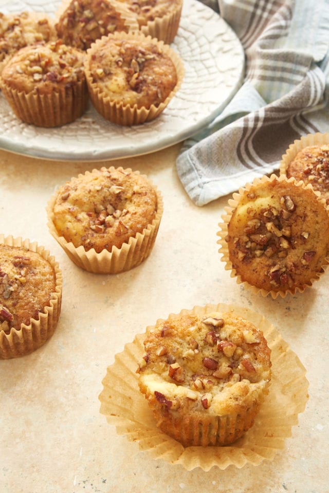 Banana Cream Cheese Muffins on a beige surface