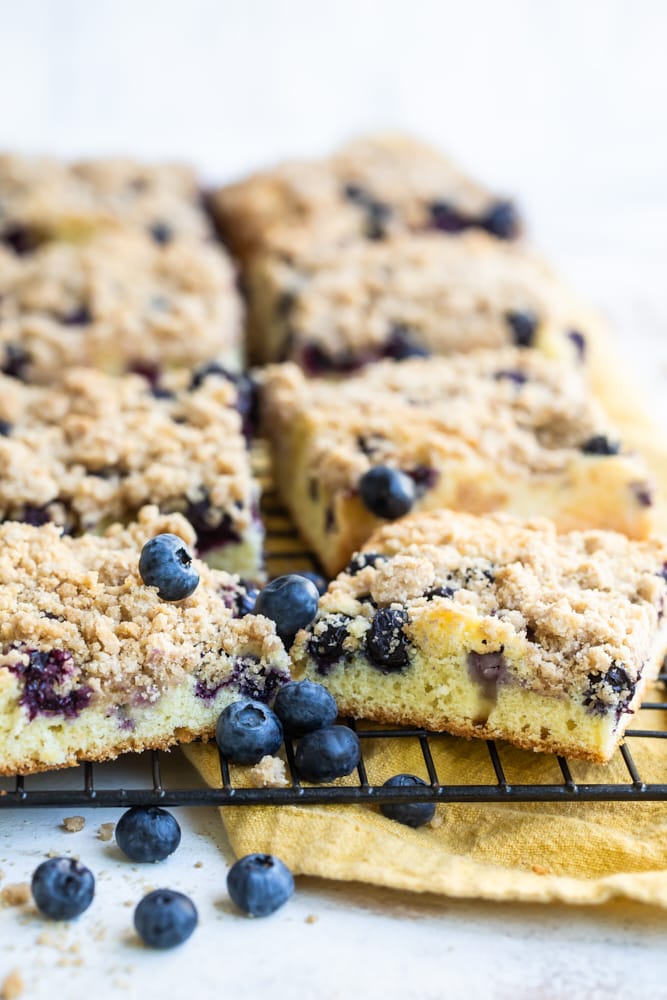 Pieces of blueberry crumb cake on wire rack