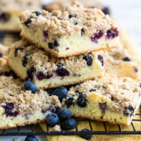 sliced of Blueberry Crumb Cake stacked on a wire rack