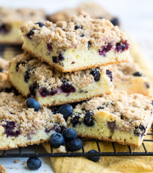sliced of Blueberry Crumb Cake stacked on a wire rack
