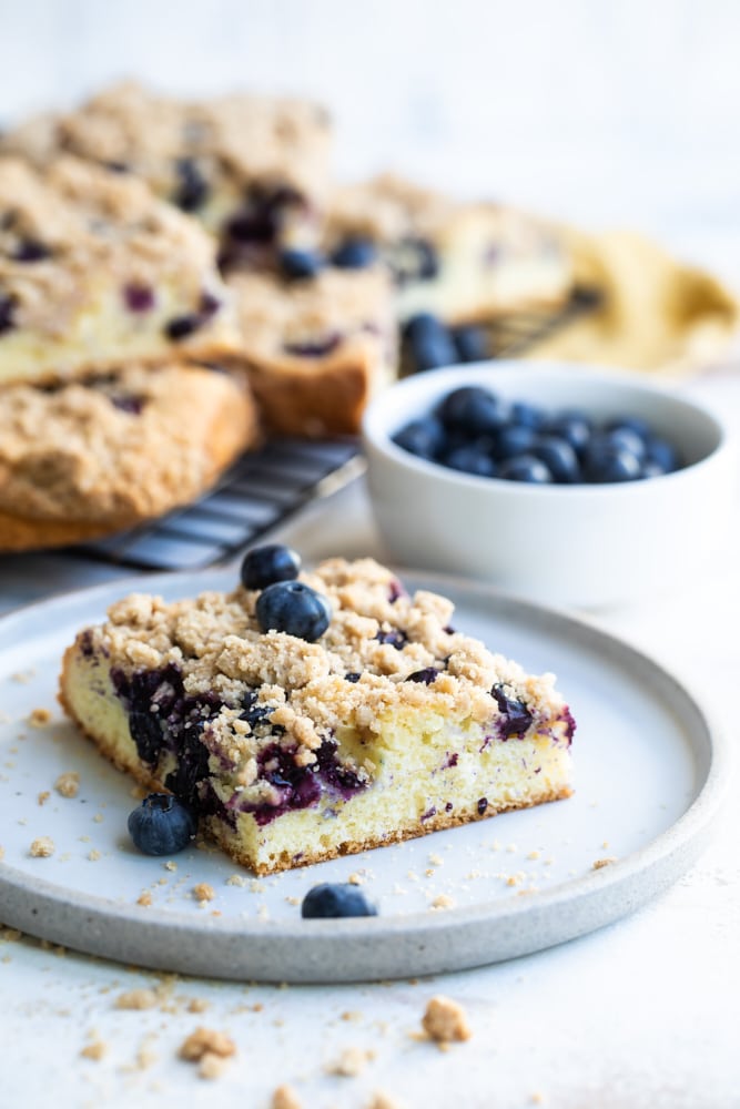 slice of Blueberry Crumb Cake on a white plate