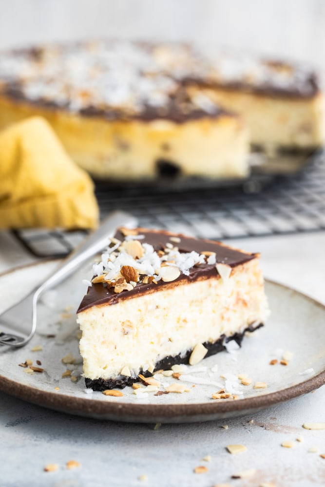 slice of Chocolate Coconut Almond Cheesecake on a beige plate