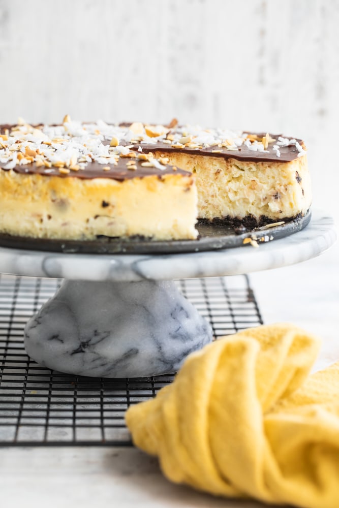 Chocolate Coconut Almond Cheesecake on a marble cake stand