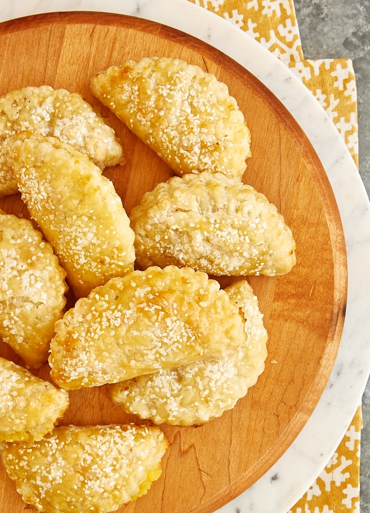 overhead view of Ginger Lemon Hand Pies on a wooden serving tray