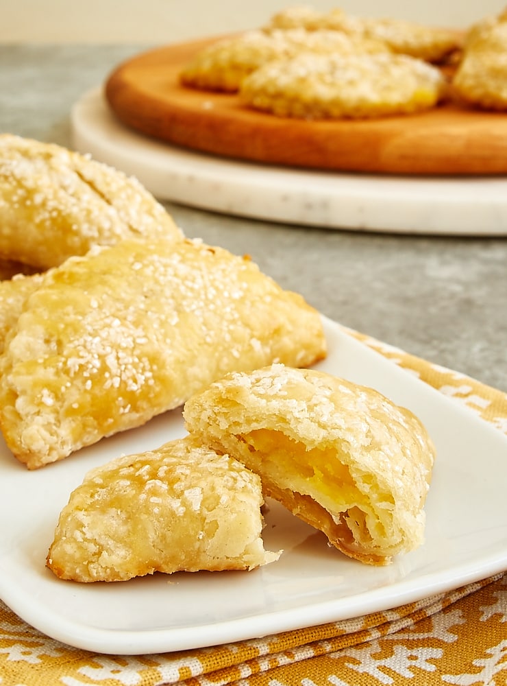 Ginger Lemon Hand Pie cut in half on a white serving plate