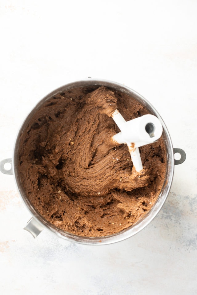 Overhead view of hazelnut crinkle cookies dough in a mixing bowl.