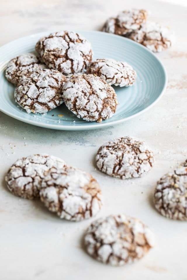 Hazelnut Crinkle Cookies on a light blue plate with more cookies around the plate