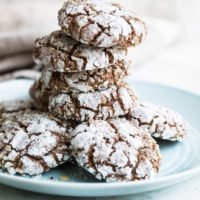 Hazelnut Crinkle Cookies stacked on a light blue plate