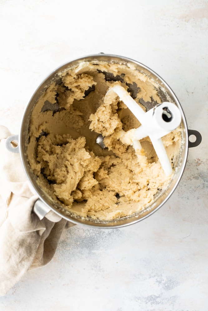 overhead view of creamed butter and brown sugar in a mixing bowl