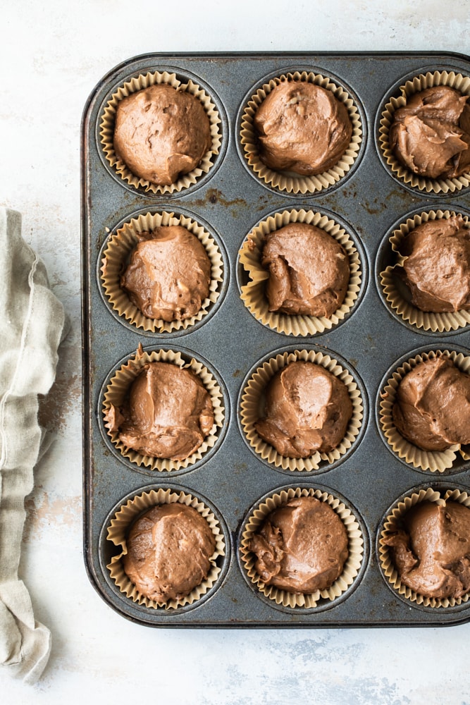 overhead view of Mexican Chocolate Cupcakes with Dulce de Leche Frosting batter portioned into a muffin pan