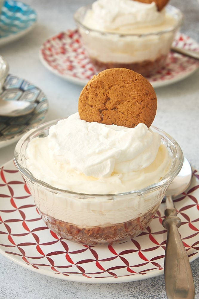 No-Bake Lemon Cheesecake in a glass serving bowl on a colorful plate