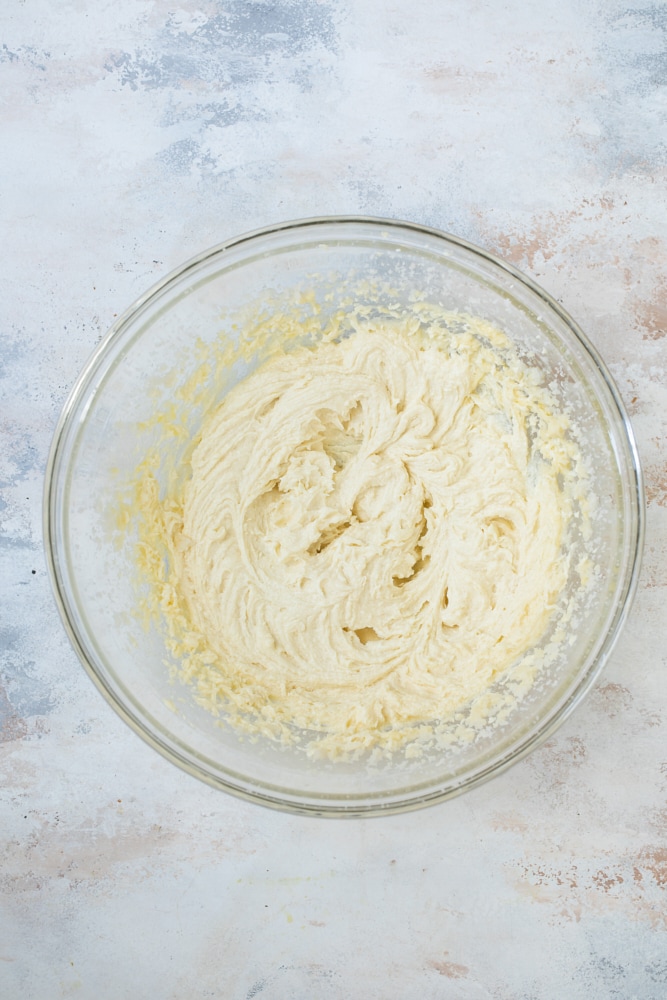 Overhead view of cake batter in glass bowl