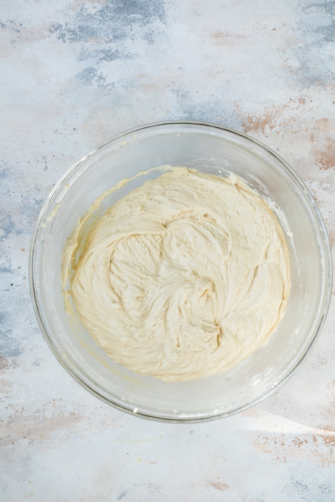 Overhead view of bundt cake batter in glass mixing bowl