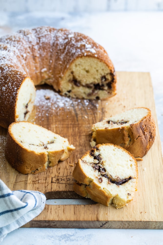 sliced Sour Cream Hazelnut Bundt Cake on a wooden cutting board