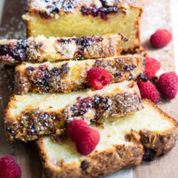 sliced Raspberry White Chocolate Almond Loaf on a wooden cutting board