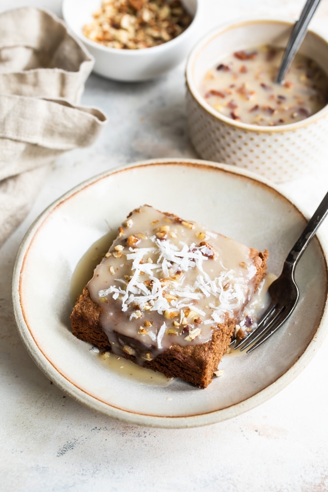 Slice of German chocolate cake on a beige plate, with a fork.