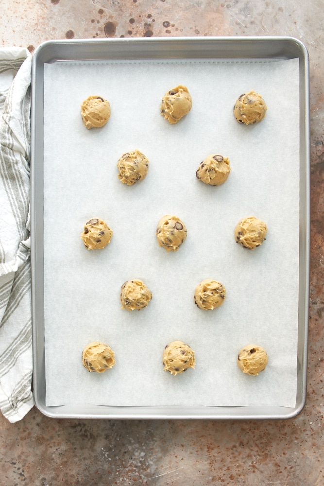 overhead view of Greek Yogurt Chocolate Chip Cookie dough on a parchment-lined baking sheet
