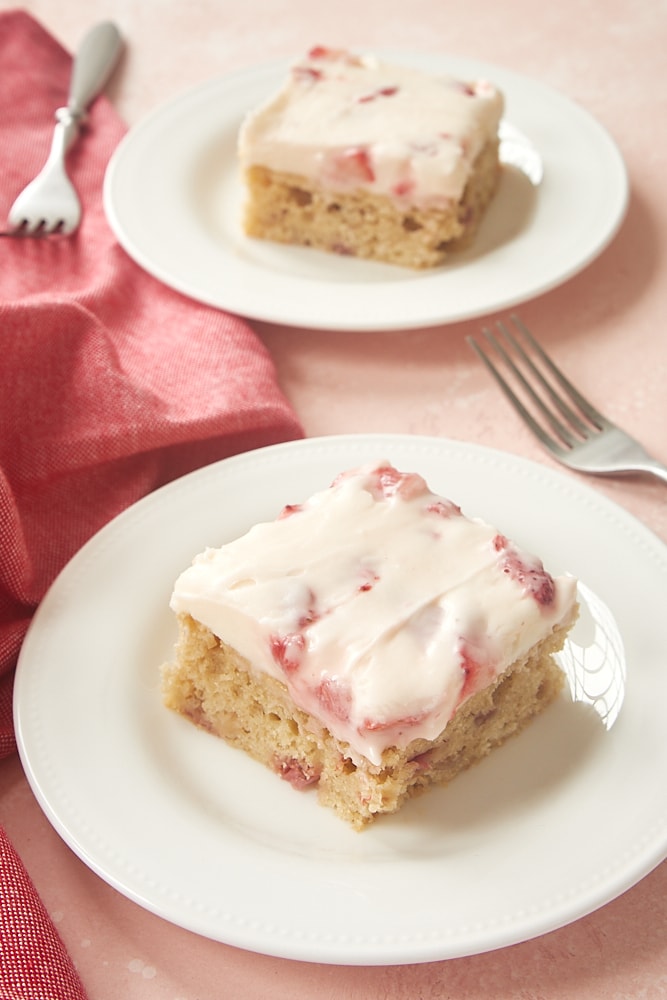 slices of Strawberry Sheet Cake on white plates