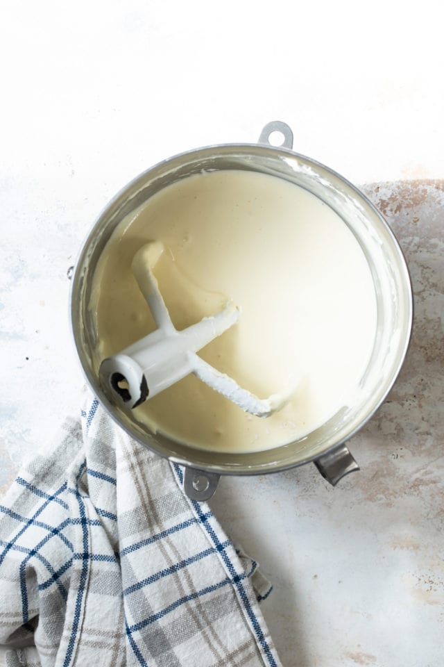 Overhead view of cheesecake batter in a mixing bowl.