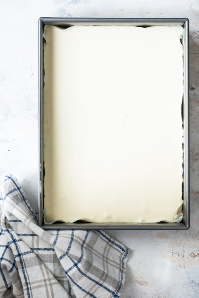 Overhead view of vanilla cheesecake bars ready for the oven.