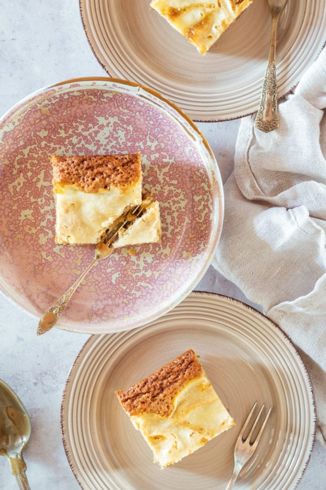 overhead view of Butterscotch Cream Cheese Swirl Bars on beige and pink plates