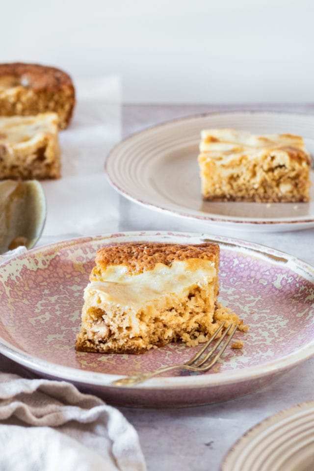 Butterscotch Cream Cheese Swirl Bars served on beige and pink plates