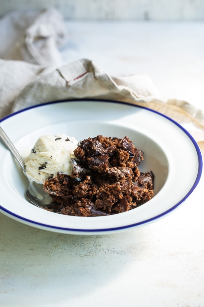 Serving of Brownie Chocolate Pudding Cake in bowl with ice cream