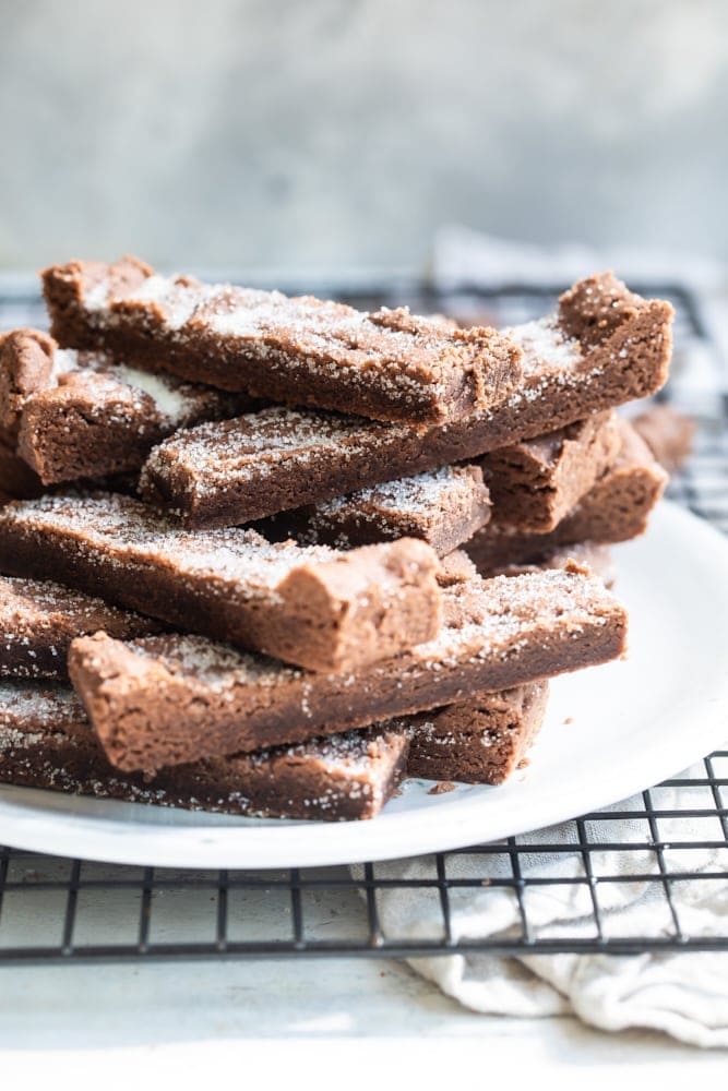 Chocolate shortbread stacked on a white plate.