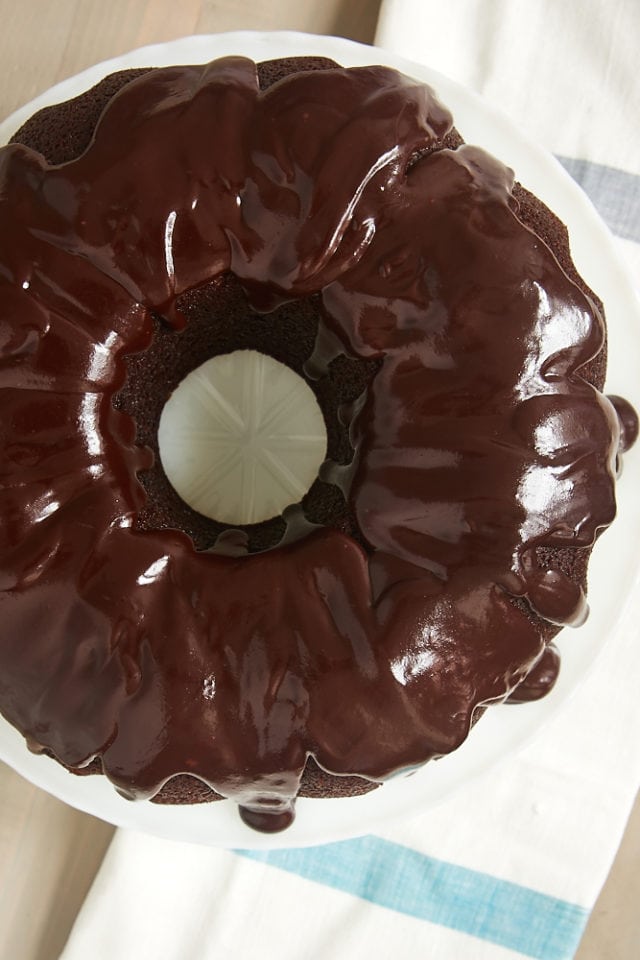 overhead view of Chocolate Sour Cream Bundt Cake on a white cake stand