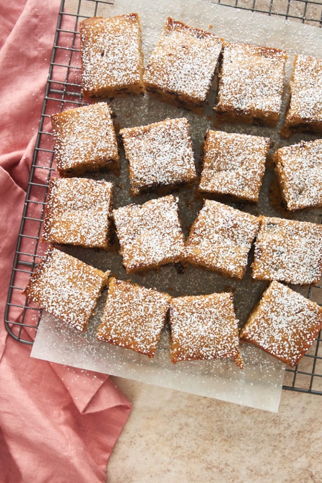 overhead view of Chocolate Chip Cookie Butter Snack Cake on parchment paper on a wire rack