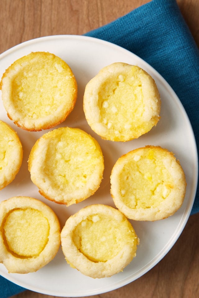 overhead view of Lemon Chess Tartlets on a white cake stand