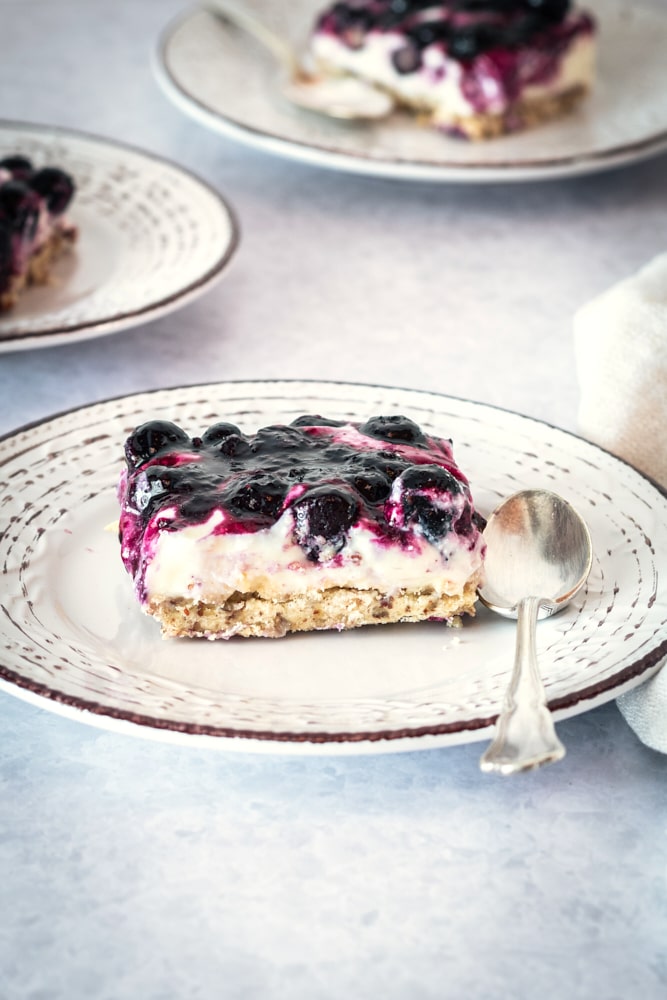 Blueberry jamboree slice on plate with spoon