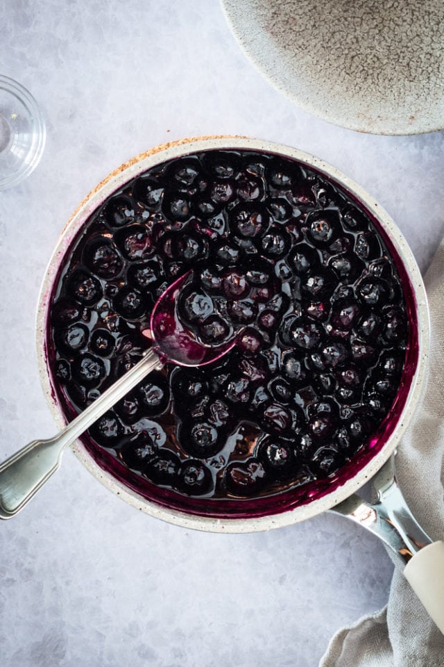Overhead view of cooked blueberry sauce in pan