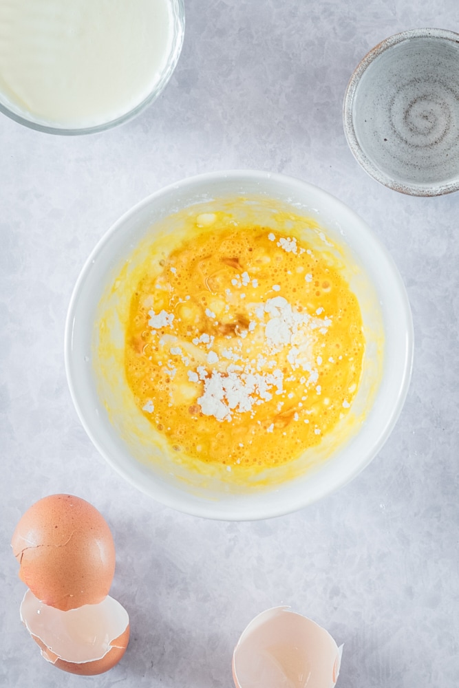 Overhead view of egg mixture in mixing bowl