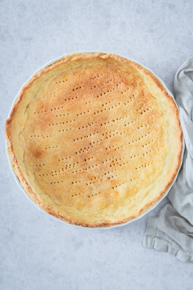 overhead view of baked crust in a pie plate