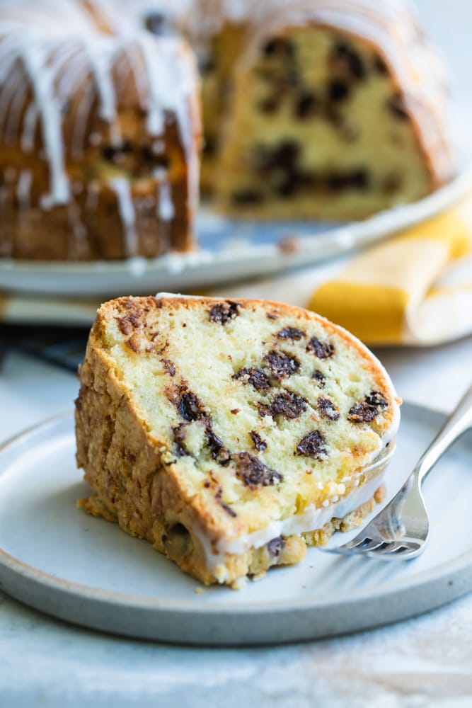 slice of Chocolate Chip Almond Cake on a light gray plate