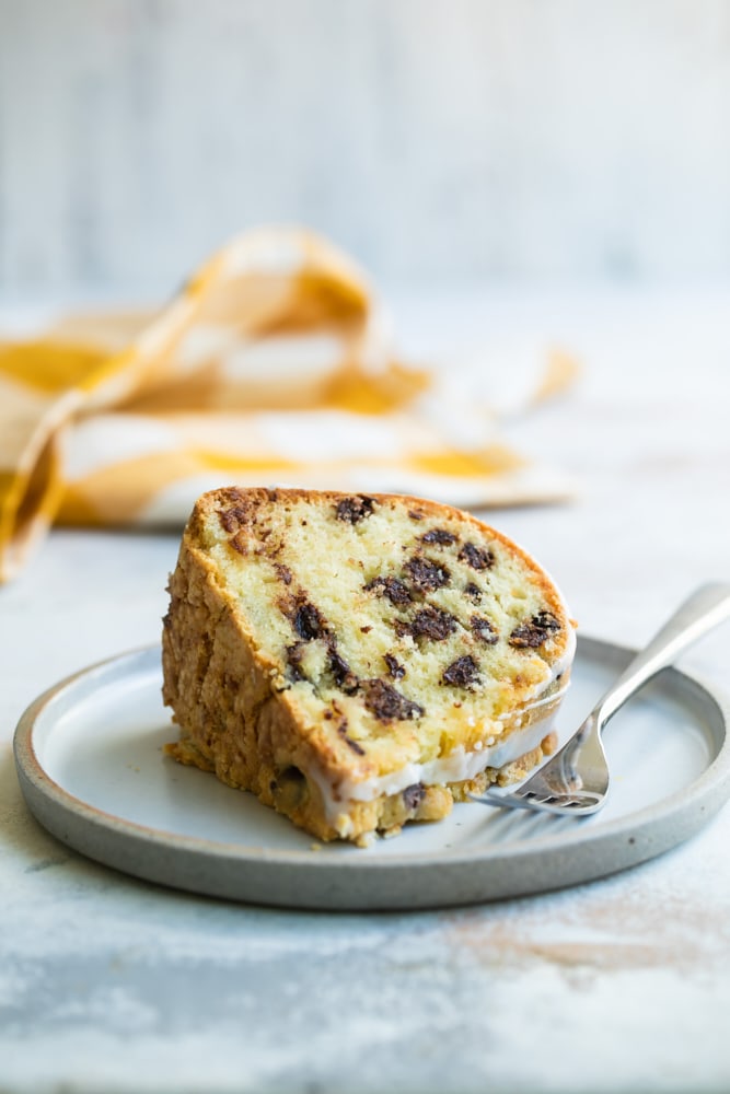 Slice of chocolate chip almond cake on plate with fork