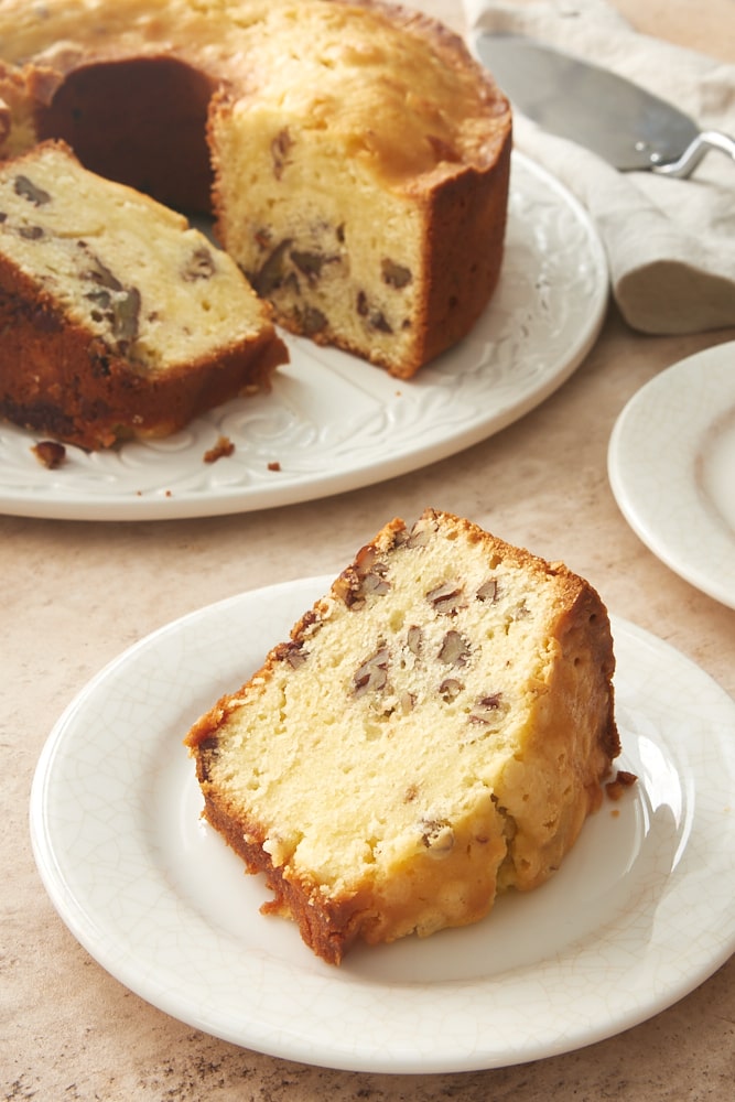 slice of Cream Cheese Pecan Pound Cake on a white plate