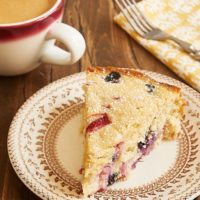 slice of Berry Muffin Cake on a floral-rimmed beige plate