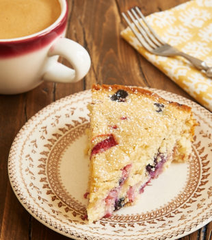 slice of Berry Muffin Cake on a floral-rimmed beige plate